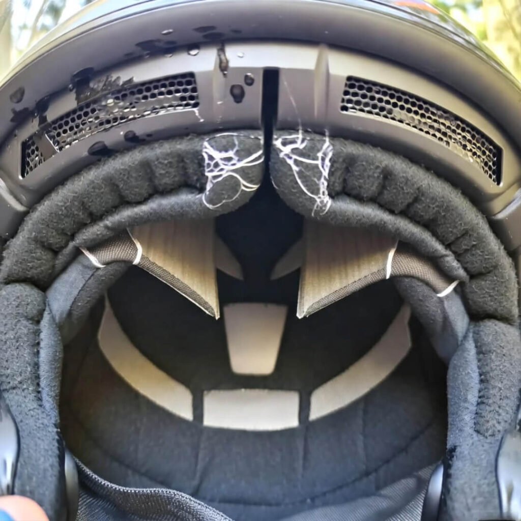 Cracked helmet interior with sweat stains.